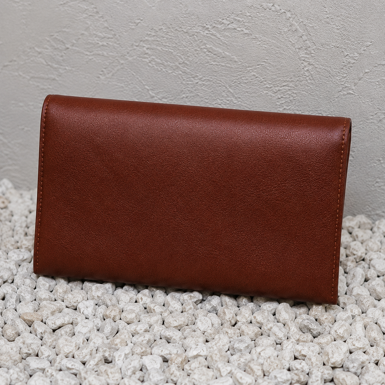 Back view of the Imara handcrafted leather clutch with a smooth genuine brown leather finish.