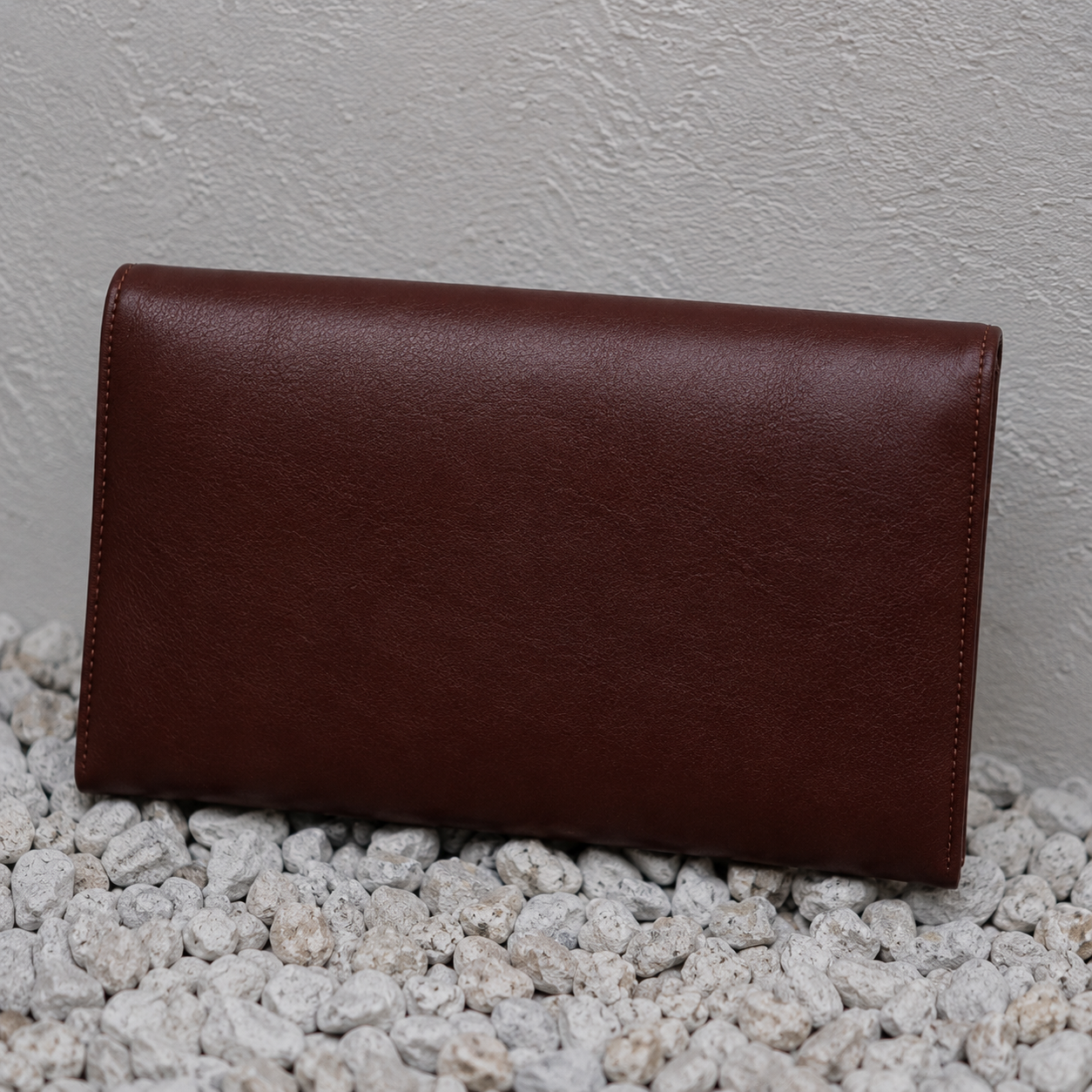 Back view of the Nia handcrafted leather clutch with a smooth genuine brown leather finish
